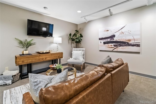 carpeted living room featuring track lighting