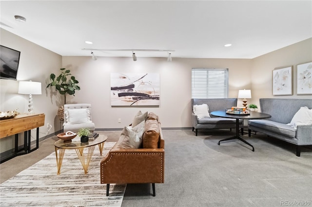 carpeted living room featuring track lighting