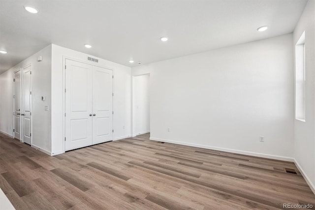 317 W Owen Ave, Keenesburg, CO 80643 - unfurnished bedroom featuring wood finished floors, baseboards, recessed lighting, and a closet