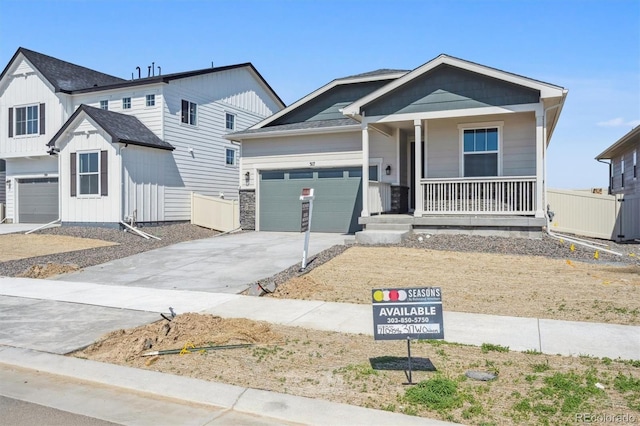 317 W Owen Ave, Keenesburg, CO 80643 - view of front of house with a porch, driveway, and a garage