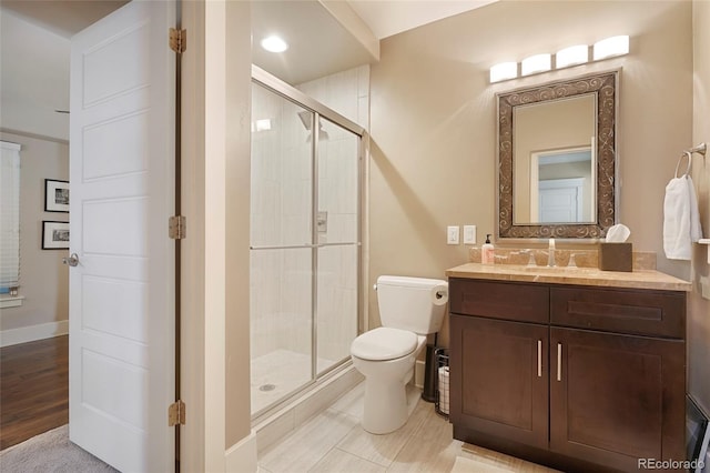 bathroom featuring vanity, hardwood / wood-style floors, an enclosed shower, and toilet