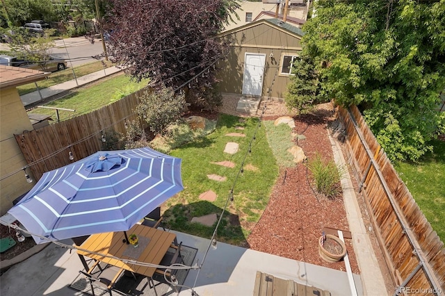 view of yard with a storage unit and a patio