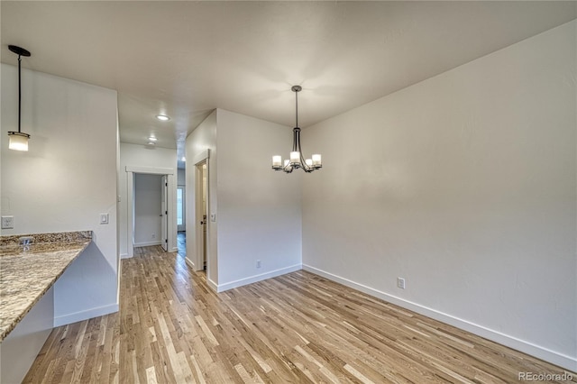 interior space featuring light hardwood / wood-style flooring and an inviting chandelier