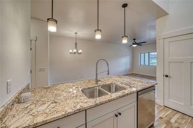 kitchen featuring sink, pendant lighting, stainless steel dishwasher, light wood-type flooring, and ceiling fan with notable chandelier