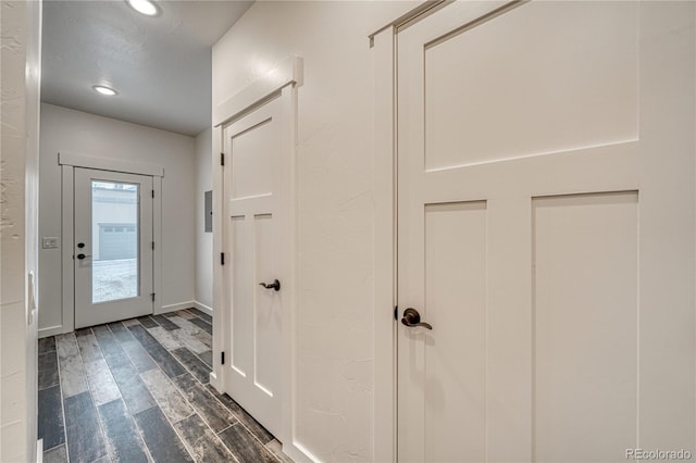 hallway with dark hardwood / wood-style flooring