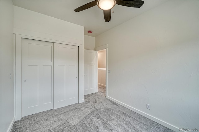 unfurnished bedroom featuring a closet, ceiling fan, and light colored carpet