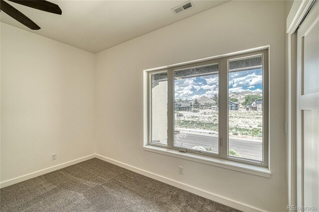 empty room featuring carpet and ceiling fan