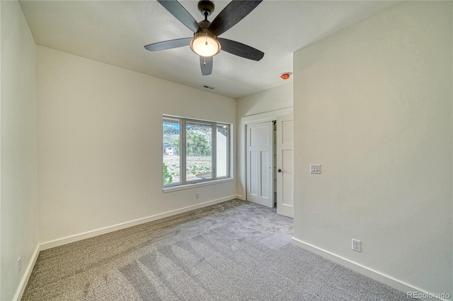 empty room with carpet flooring and ceiling fan