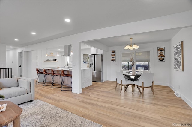 living room with a chandelier and light hardwood / wood-style flooring