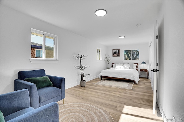 bedroom with light wood-style floors and baseboards