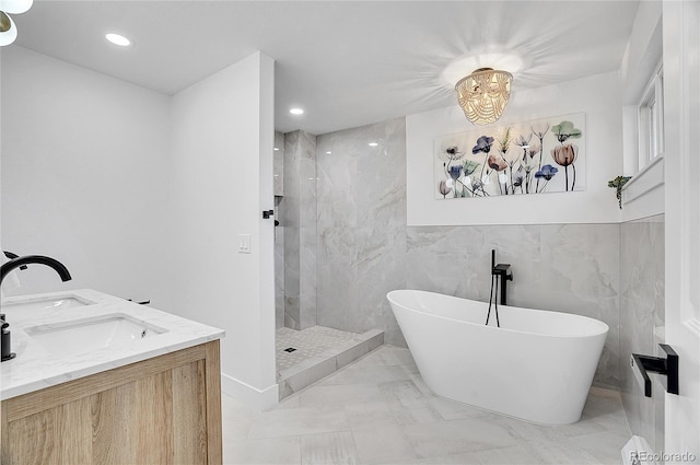 bathroom with double vanity, recessed lighting, a sink, a tile shower, and a freestanding tub