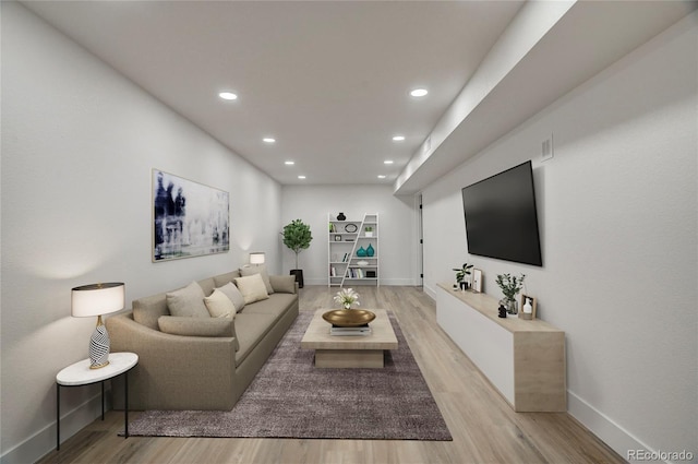 living area featuring light wood finished floors, baseboards, and recessed lighting