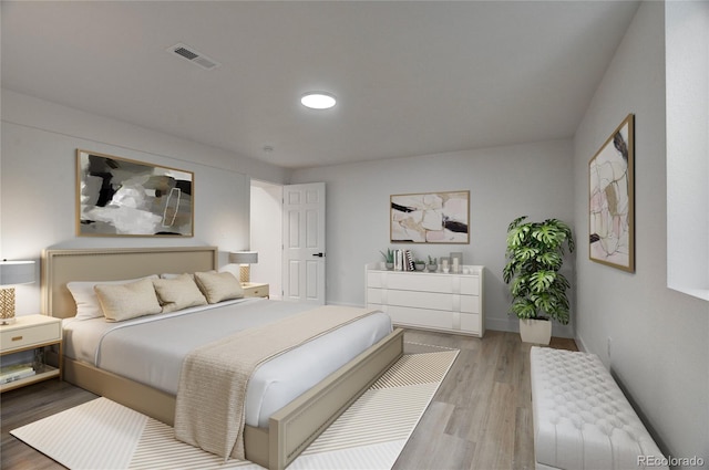 bedroom featuring baseboards, visible vents, and light wood-style floors