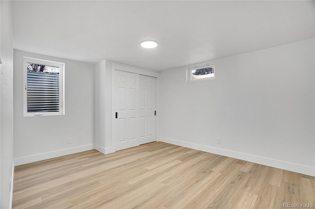 basement with light hardwood / wood-style floors