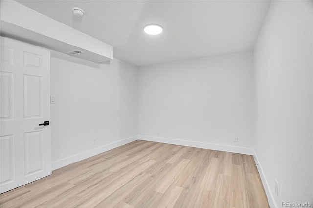 unfurnished room with visible vents, light wood-style flooring, and baseboards