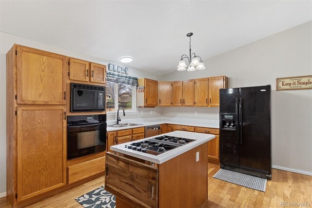 5220 Topaz Dr, Colorado Springs, CO 80918 - kitchen featuring black appliances, a sink, light countertops, vaulted ceiling, and light wood-type flooring