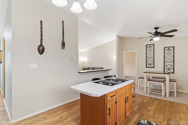 5220 Topaz Dr, Colorado Springs, CO 80918 - kitchen with stainless steel gas cooktop, light wood-style flooring, a ceiling fan, light countertops, and baseboards