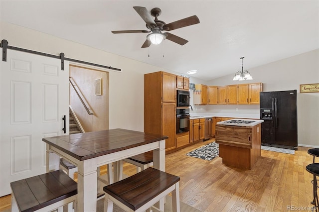 5220 Topaz Dr, Colorado Springs, CO 80918 - kitchen with black appliances, a barn door, vaulted ceiling, light countertops, and ceiling fan