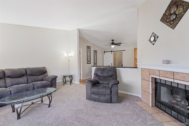 5220 Topaz Dr, Colorado Springs, CO 80918 - living room with lofted ceiling, light colored carpet, baseboards, ceiling fan, and a tile fireplace
