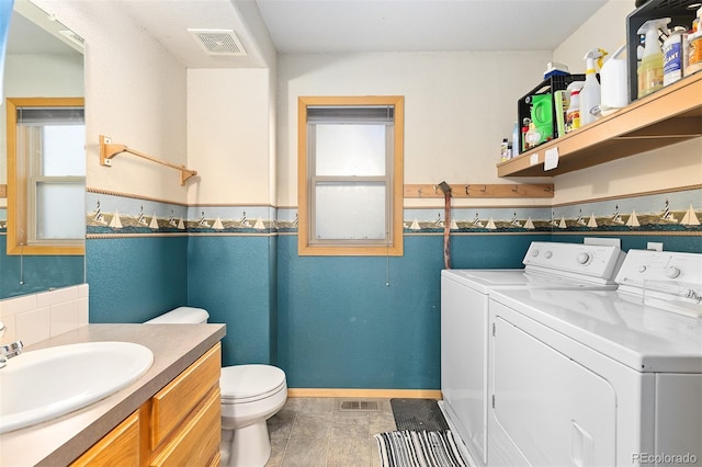 7209 W 21st St, Greeley, CO 80634 - bathroom with vanity, separate washer and dryer, and toilet