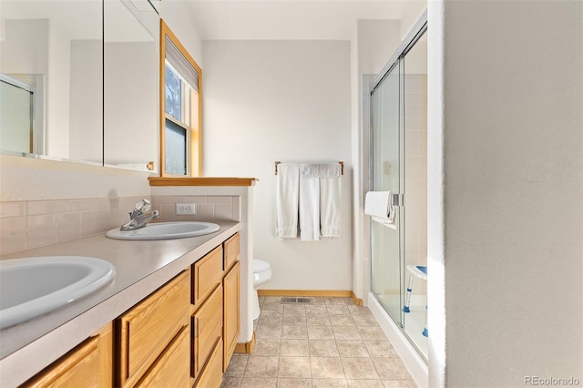 7209 W 21st St, Greeley, CO 80634 - bathroom with vanity, a shower with shower door, and toilet