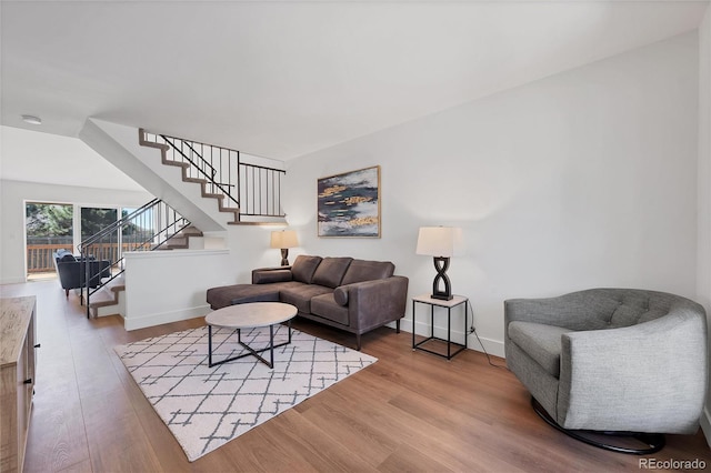 714 Sedge Way, Lafayette, CO 80026 - living area featuring stairs, wood finished floors, and baseboards