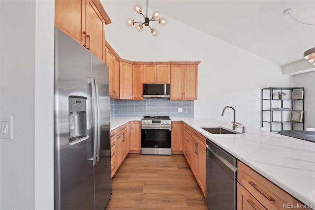 714 Sedge Way, Lafayette, CO 80026 - kitchen with stainless steel appliances, a sink, light brown cabinetry, light wood-type flooring, and light countertops