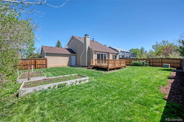714 Sedge Way, Lafayette, CO 80026 - back of property featuring a vegetable garden and a deck