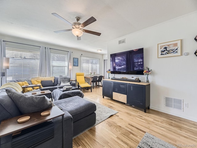 living room featuring ceiling fan and light hardwood / wood-style flooring