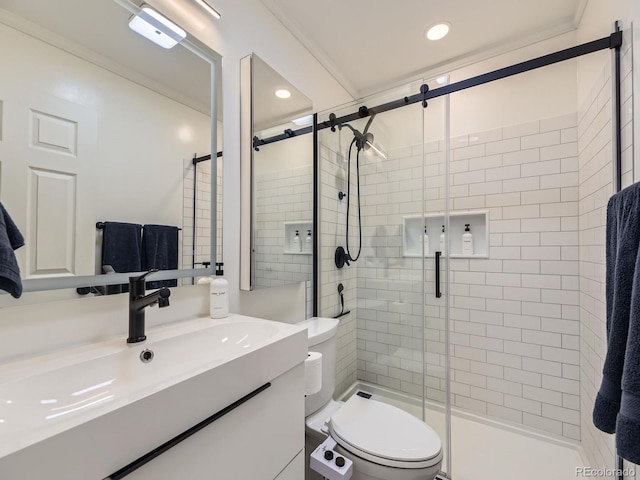 bathroom with vanity, toilet, walk in shower, and ornamental molding