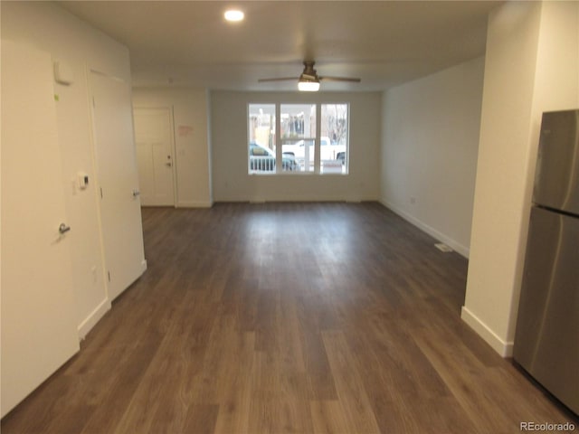 unfurnished room with ceiling fan and dark wood-type flooring