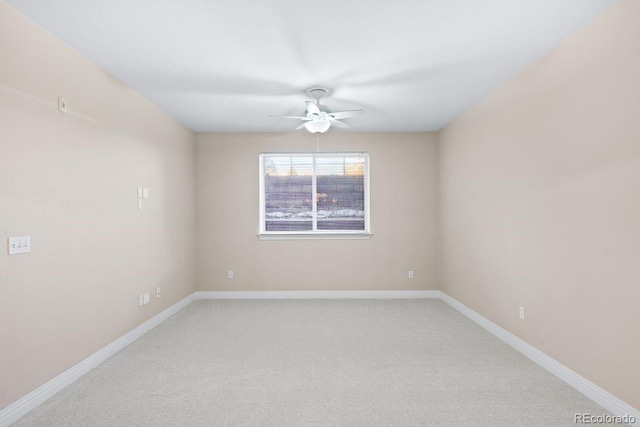 empty room featuring ceiling fan and light carpet