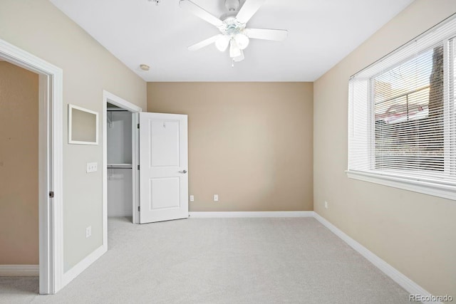 unfurnished bedroom featuring ceiling fan, a closet, and light carpet