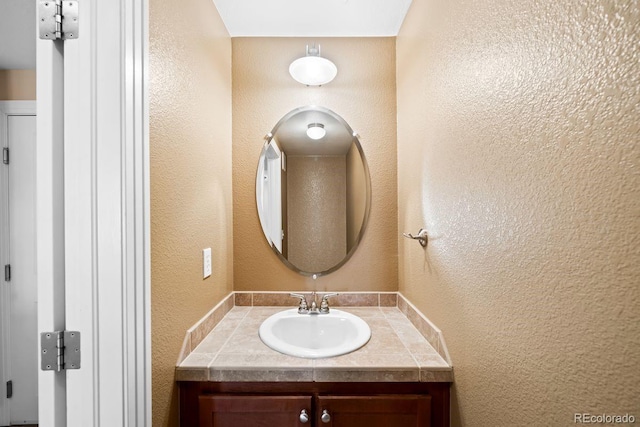 9019 E Panorama Cir Unit D211, Englewood, CO 80112 - bathroom featuring vanity and a textured wall