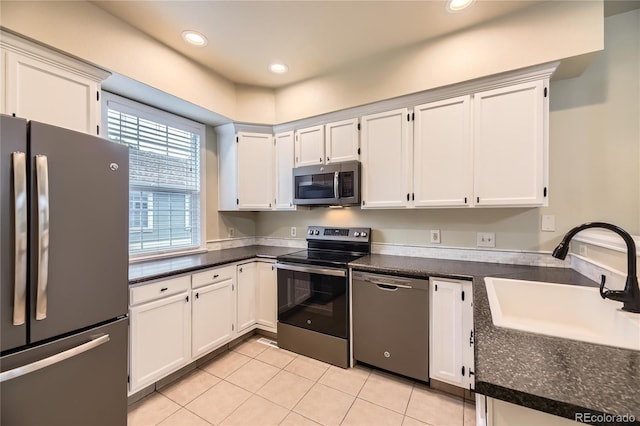 2902 W Long Cir Unit B, Littleton, CO 80120 - kitchen featuring appliances with stainless steel finishes, a sink, light tile patterned flooring, white cabinetry, and recessed lighting