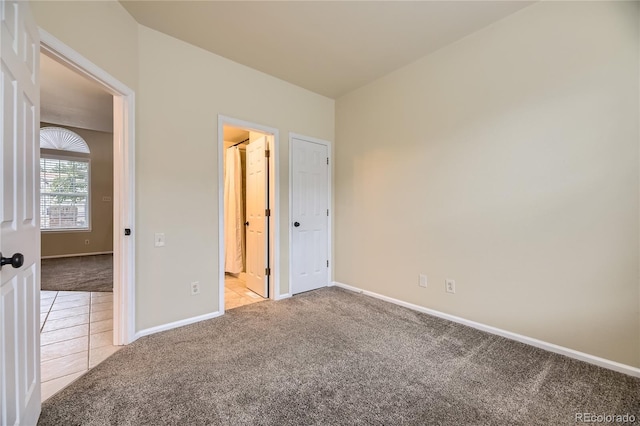 2902 W Long Cir Unit B, Littleton, CO 80120 - unfurnished bedroom with light carpet and baseboards