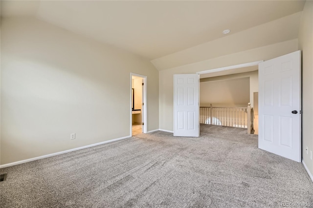 2902 W Long Cir Unit B, Littleton, CO 80120 - unfurnished bedroom featuring lofted ceiling, carpet floors, baseboards, and ensuite bathroom
