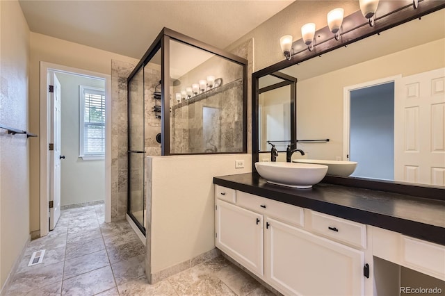 2902 W Long Cir Unit B, Littleton, CO 80120 - bathroom featuring a shower stall, vanity, and baseboards