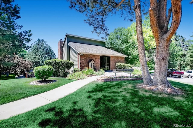2902 W Long Cir Unit B, Littleton, CO 80120 - view of front of property with a chimney, brick siding, and a front lawn