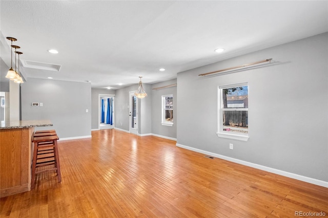 unfurnished living room with light hardwood / wood-style flooring