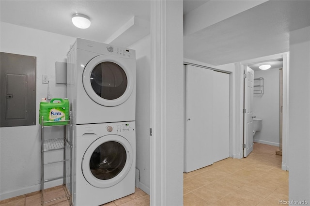 washroom featuring stacked washer / dryer and electric panel