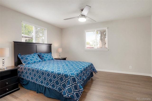 bedroom with ceiling fan and wood-type flooring