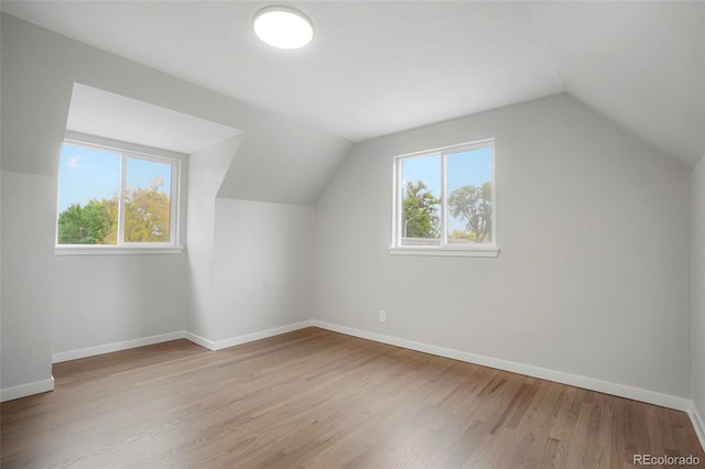 bonus room featuring light hardwood / wood-style flooring and vaulted ceiling