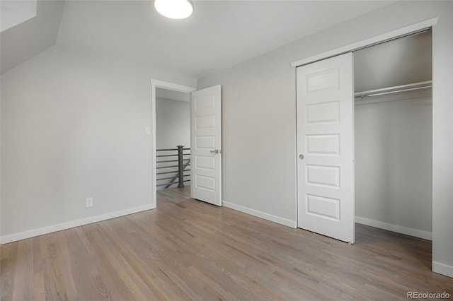 unfurnished bedroom with a closet and light hardwood / wood-style floors