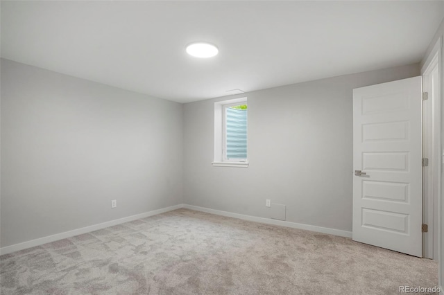 spare room featuring light colored carpet