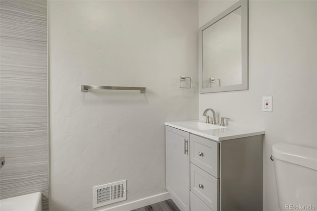 bathroom with vanity and toilet