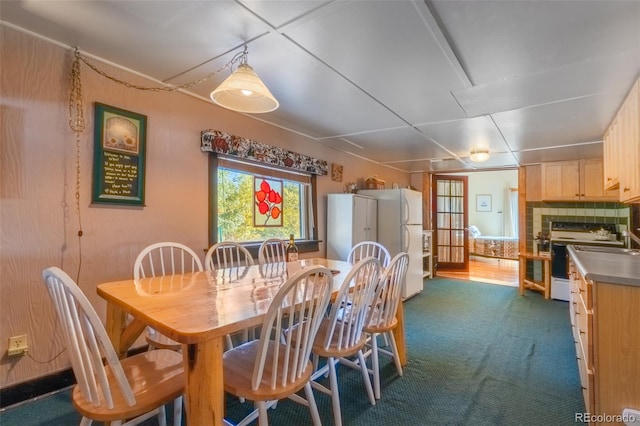 dining room featuring dark colored carpet