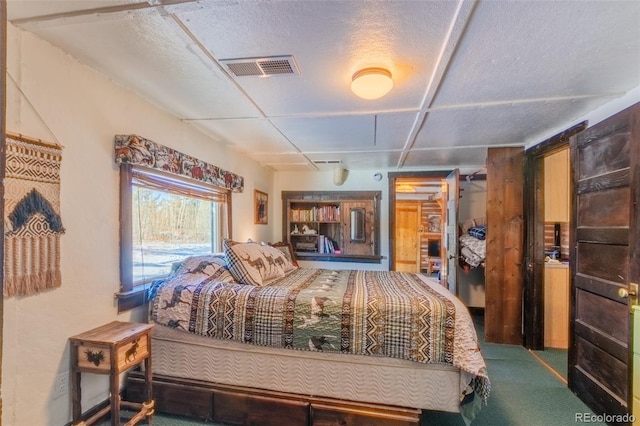 carpeted bedroom featuring a textured ceiling