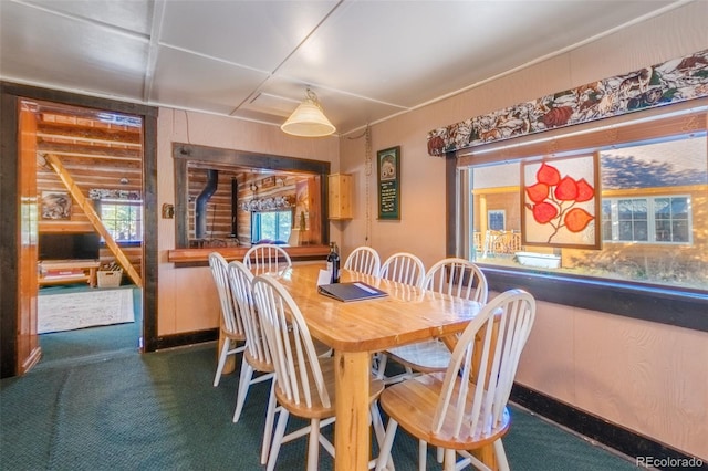 dining room with bar and dark colored carpet