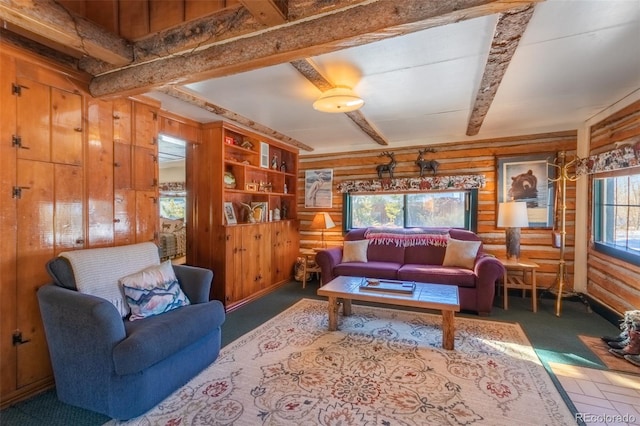 living room featuring wooden walls, beam ceiling, and dark colored carpet